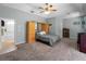 Large bedroom with carpeted floors, a ceiling fan, and an en suite bathroom at 2288 Prague Ln, Punta Gorda, FL 33983