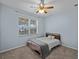 Bedroom featuring carpeted floors, a ceiling fan, light blue walls and a bed with neutral colored bedding at 2288 Prague Ln, Punta Gorda, FL 33983