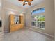 Dining room featuring a built-in bar with glass shelves and a large window at 2288 Prague Ln, Punta Gorda, FL 33983