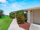 Charming single-story home with mature landscaping, mulched flower beds, and an attached garage at 2288 Prague Ln, Punta Gorda, FL 33983