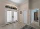Bright foyer with tiled floors and arched window above double front doors for natural light at 2288 Prague Ln, Punta Gorda, FL 33983
