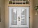 Elegant front door with glass panels, transom window, and stylish hardware at 2288 Prague Ln, Punta Gorda, FL 33983
