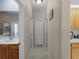 Hallway with tile floors connecting the bathroom and kitchen, featuring multiple white doors and neutral-colored walls at 2288 Prague Ln, Punta Gorda, FL 33983