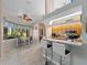 Eat-in kitchen with light wood cabinets, breakfast bar, and a dining nook with views of the backyard at 2288 Prague Ln, Punta Gorda, FL 33983