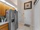 Kitchen featuring stainless steel refrigerator and a door leading to the hallway at 2288 Prague Ln, Punta Gorda, FL 33983