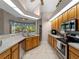 Bright kitchen with lots of windows, wood cabinets, and stainless steel appliances at 2288 Prague Ln, Punta Gorda, FL 33983