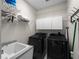 This modern laundry room has new black appliances, white cabinets, and a wash basin at 2288 Prague Ln, Punta Gorda, FL 33983