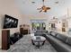 Spacious living room with a fireplace, tile flooring, ceiling fan, and access to outdoor living space at 2288 Prague Ln, Punta Gorda, FL 33983