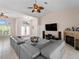 Open-concept living area with tile flooring, vaulted ceiling, fireplace, and sliding glass doors at 2288 Prague Ln, Punta Gorda, FL 33983