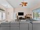 Open living room featuring high ceilings, cozy fireplace, tile floors and access to outdoor space at 2288 Prague Ln, Punta Gorda, FL 33983