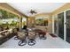 The outdoor patio has a dining table and chairs, with open windows to view the landscape at 2288 Prague Ln, Punta Gorda, FL 33983