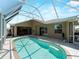 This screened-in pool features a lounging area with access to the home and beautiful sky views at 2288 Prague Ln, Punta Gorda, FL 33983
