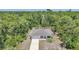 Aerial view of house surrounded by a lush green forest at 23470 Burlingame Ave, Punta Gorda, FL 33980