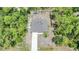 Aerial view of a home surrounded by lush trees at 23470 Burlingame Ave, Punta Gorda, FL 33980