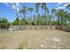 A large backyard with a wooden fence at 23470 Burlingame Ave, Punta Gorda, FL 33980