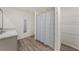 Bathroom featuring a modern vanity, updated wood-look floors, and a shower at 23470 Burlingame Ave, Punta Gorda, FL 33980