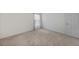 Bedroom featuring neutral carpet, white walls, and bright window at 23470 Burlingame Ave, Punta Gorda, FL 33980