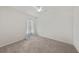 Bedroom featuring neutral carpet, white walls, and ceiling fan at 23470 Burlingame Ave, Punta Gorda, FL 33980