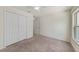 Cozy bedroom featuring neutral carpet, closet, and ceiling fan at 23470 Burlingame Ave, Punta Gorda, FL 33980