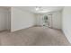 Generous bedroom with a ceiling fan, plush carpeting, and a sliding glass door to the backyard at 23470 Burlingame Ave, Punta Gorda, FL 33980