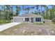 Charming single-story home featuring a neutral palette, an attached two-car garage, and a well-maintained front yard at 23470 Burlingame Ave, Punta Gorda, FL 33980