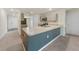 Spacious kitchen with a large countertop bar, stainless steel appliances, and open access to other living areas at 23470 Burlingame Ave, Punta Gorda, FL 33980