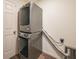 Laundry room featuring a gray stackable washer and dryer at 23470 Burlingame Ave, Punta Gorda, FL 33980