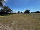 Expansive fenced backyard with mature trees and potential for landscaping or recreation at 2500 Aquilos Ct, Port Charlotte, FL 33952