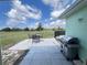 Backyard featuring a patio with outdoor seating, grilling area, and a peaceful view at 2500 Aquilos Ct, Port Charlotte, FL 33952