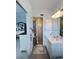Bathroom with double sinks, white cabinetry, and a tiled shower with a glass door at 2500 Aquilos Ct, Port Charlotte, FL 33952