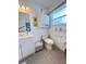Bright bathroom featuring white cabinetry, a toilet, and a tiled floor at 2500 Aquilos Ct, Port Charlotte, FL 33952