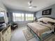 Cozy bedroom features a ceiling fan, neutral decor, and lots of natural light at 2500 Aquilos Ct, Port Charlotte, FL 33952