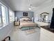 Light and airy bedroom with neutral tones, ceiling fan, and an exterior view at 2500 Aquilos Ct, Port Charlotte, FL 33952