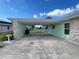 Attached carport with stone columns offers covered parking and protection from the elements at 2500 Aquilos Ct, Port Charlotte, FL 33952