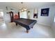 Well-lit game room with a pool table offers endless possibilities for fun and relaxation at 2500 Aquilos Ct, Port Charlotte, FL 33952