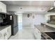 Bright kitchen with stainless steel appliances, granite counters, and a view into the living room at 2500 Aquilos Ct, Port Charlotte, FL 33952