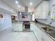 Bright kitchen with granite countertops, stainless steel appliances, and marble tile flooring at 2500 Aquilos Ct, Port Charlotte, FL 33952