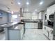 Well-lit kitchen with granite countertops, stainless steel appliances, marble tile flooring, and breakfast bar at 2500 Aquilos Ct, Port Charlotte, FL 33952