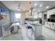 Bright kitchen with white cabinets, granite countertops, breakfast bar, stainless steel appliances, and marble tile flooring at 2500 Aquilos Ct, Port Charlotte, FL 33952