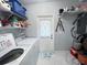 The laundry room has a modern washer and dryer with convenient shelving at 2500 Aquilos Ct, Port Charlotte, FL 33952