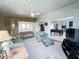 Spacious living room with cozy sofas and a pool table offers plenty of space for Gathering and friends at 2500 Aquilos Ct, Port Charlotte, FL 33952