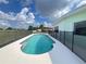 Backyard pool with protective fencing, offering privacy and safety on a sunny day at 2500 Aquilos Ct, Port Charlotte, FL 33952