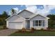 Charming one-story home featuring a two-car garage, neutral stucco, symmetrical windows and a well-manicured lawn at 25242 Estrada Cir, Punta Gorda, FL 33955