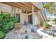 Cozy front entrance of condo unit featuring stone landscaping, exterior staircase, and neutral paint at 26336 Nadir Rd # 10, Punta Gorda, FL 33983