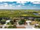 Aerial view of the property showcasing its proximity to water, lush greenery, and a serene residential setting at 31037 Prairie Creek Dr, Punta Gorda, FL 33982