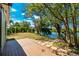 Backyard with a wood deck and access to waterfront views, with lush trees at 31037 Prairie Creek Dr, Punta Gorda, FL 33982