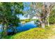 Backyard view of the water with greenery and trees creating a natural and serene view at 31037 Prairie Creek Dr, Punta Gorda, FL 33982