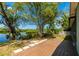 Backyard with a wood deck and access to waterfront views, with lush trees at 31037 Prairie Creek Dr, Punta Gorda, FL 33982