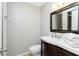 Bathroom with a modern vanity, framed mirror, and convenient towel storage at 31037 Prairie Creek Dr, Punta Gorda, FL 33982