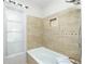 Bathroom tiled shower and tub combination with a window and a toiletry shelf at 31037 Prairie Creek Dr, Punta Gorda, FL 33982